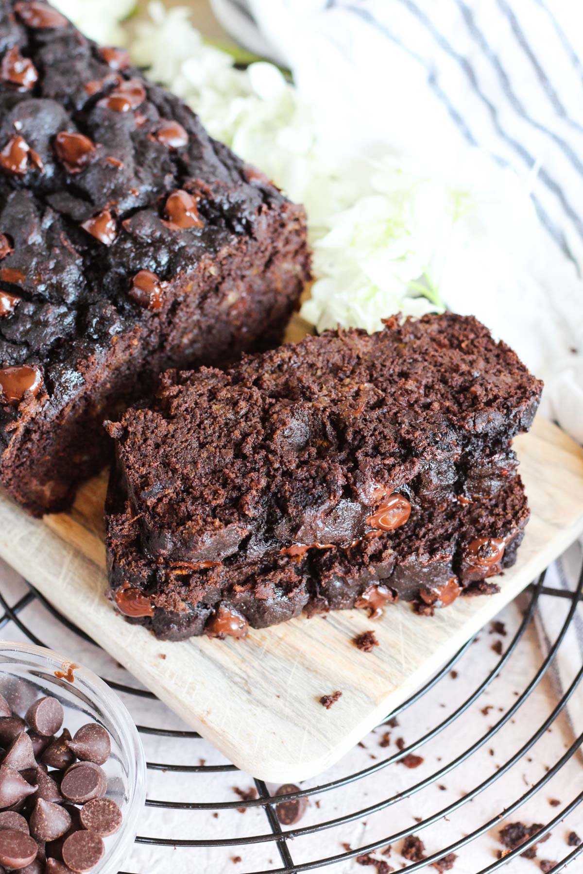 Slices of chocolate banana bread on wooden cutting board.