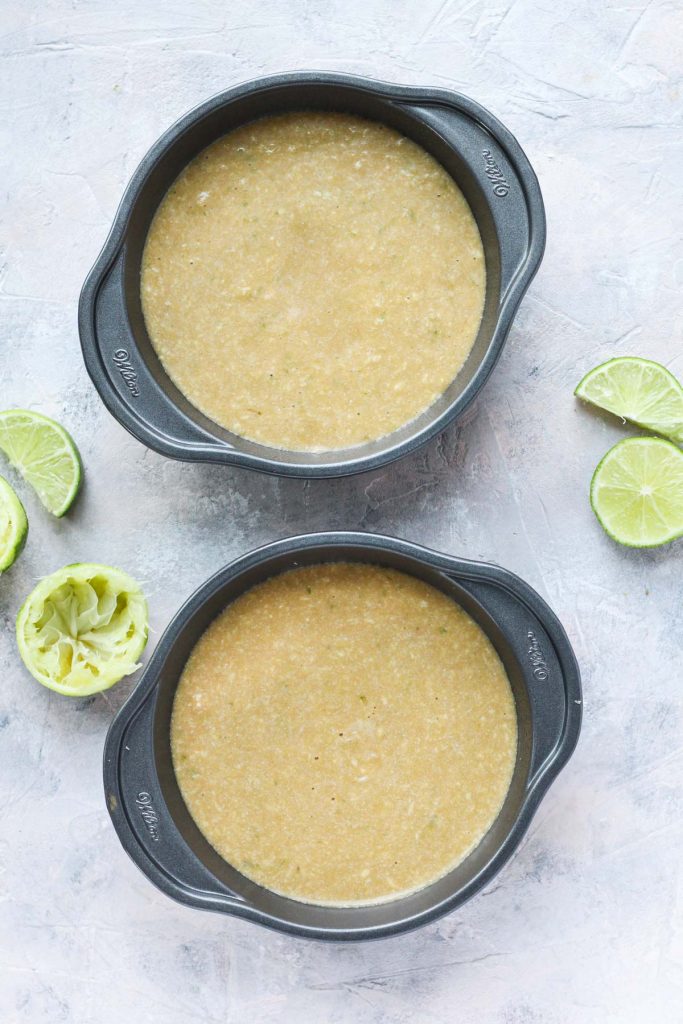 Cake batter in two small baking pans.