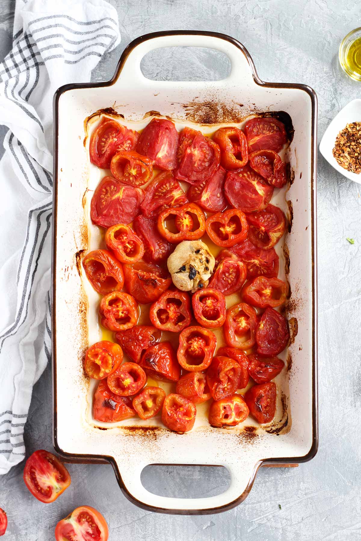 Roasted tomatoes and garlic in a pan.