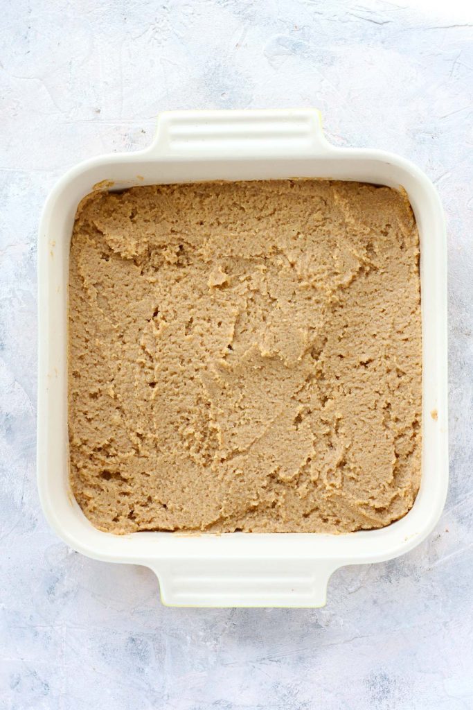 Cake batter spread out in baking dish.