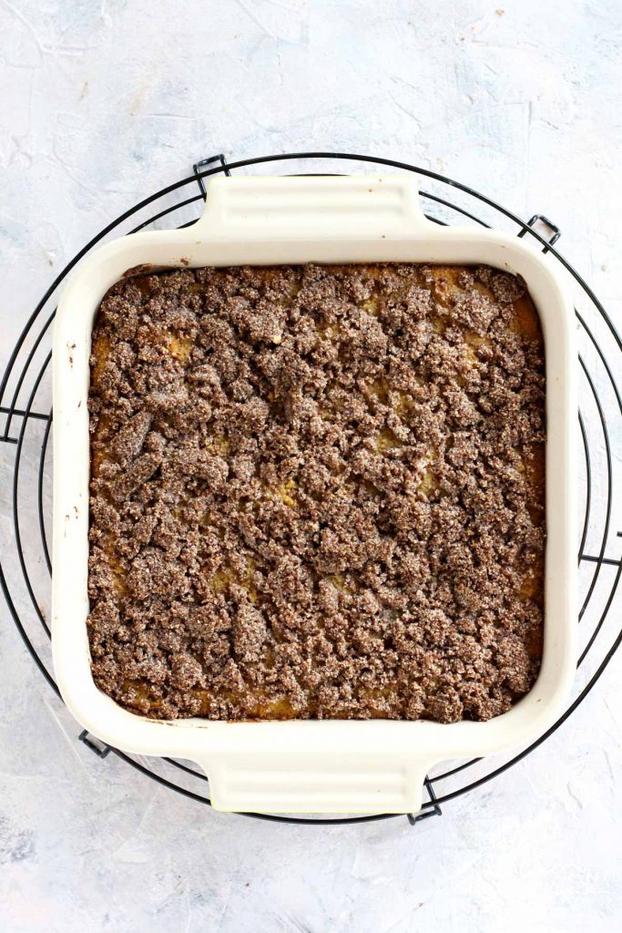 Coffee cake cooling on metal rack.