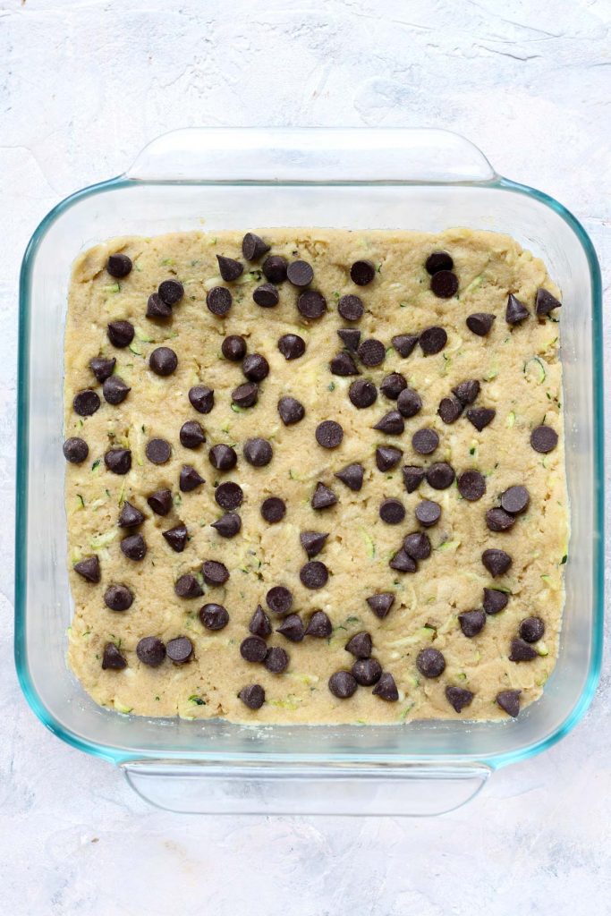 Cake in glass baking dish with chocolate chips on top.