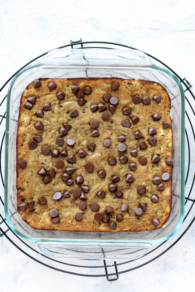 Baked cake cooling on metal rack.