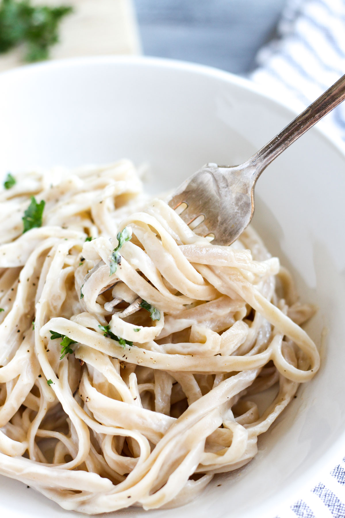 Fork twirling in plate of pasta.