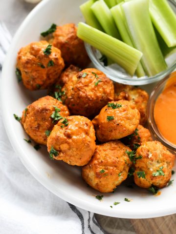 Buffalo meatballs in a white bowl.