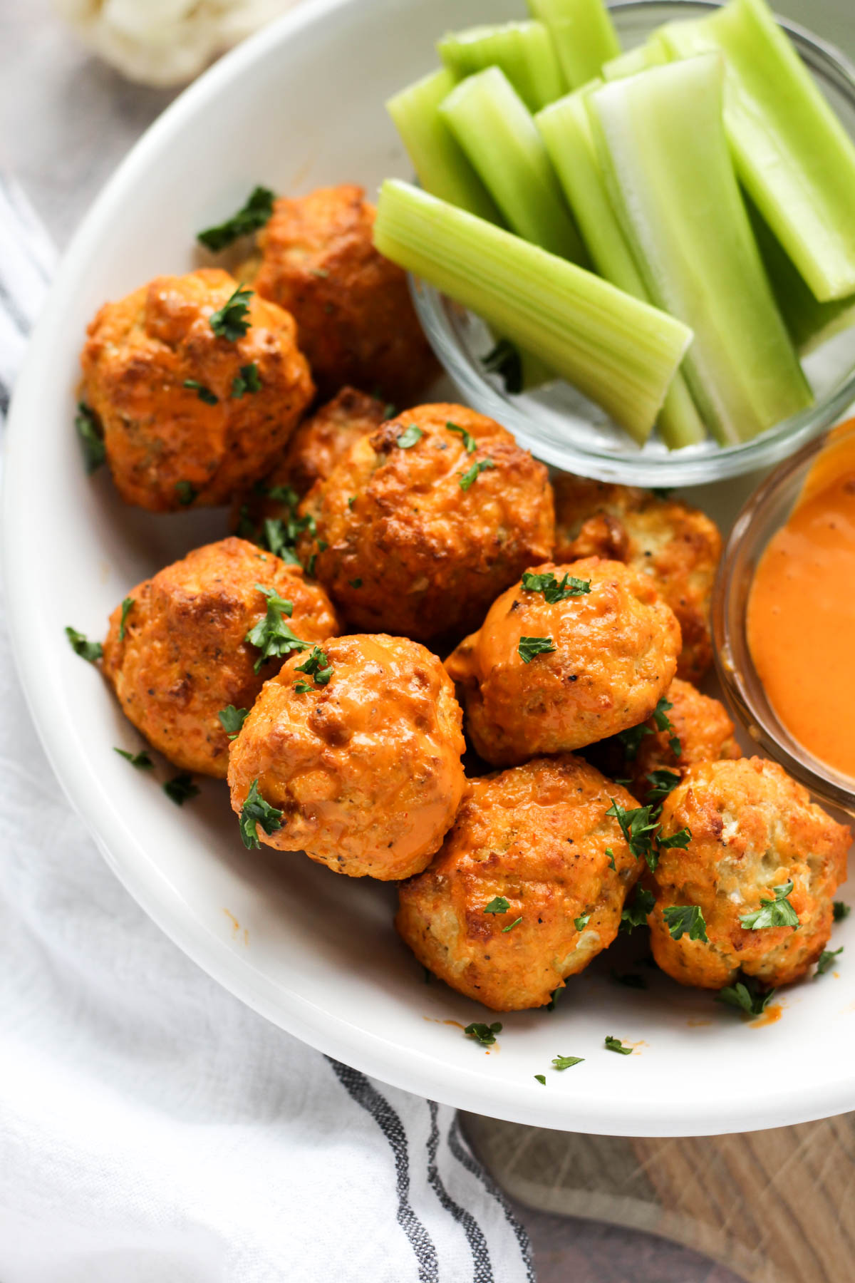 Buffalo meatballs in a white bowl.