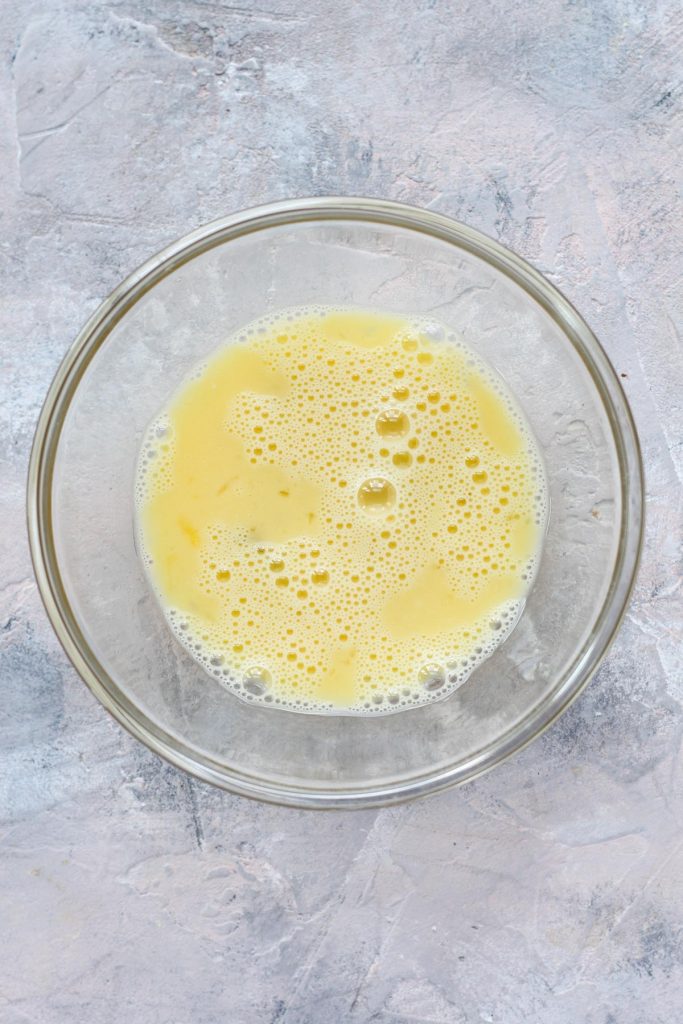 Whipped eggs in a glass bowl.