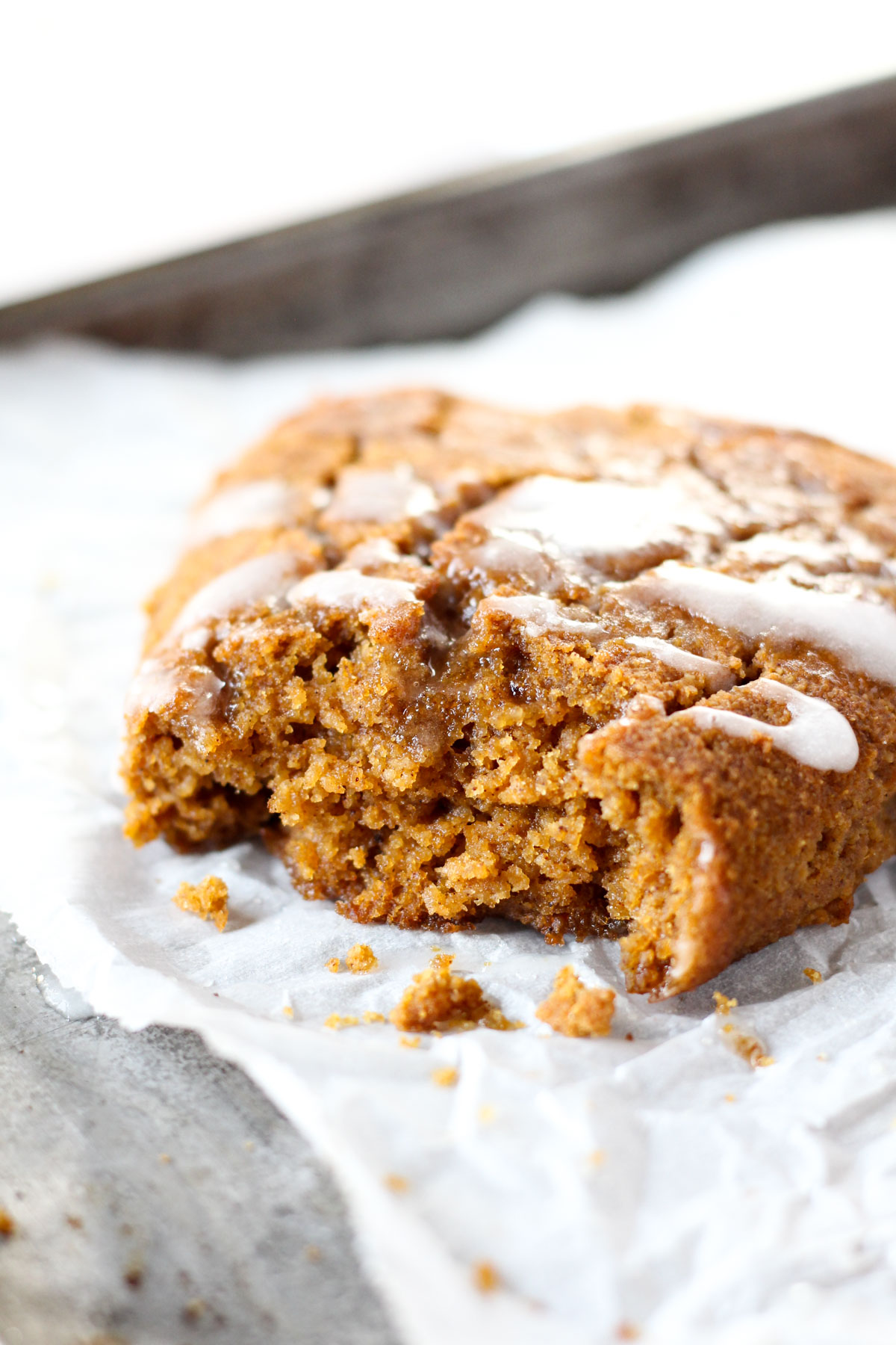 Close up of pumpkin spice scones with a bite taken out.
