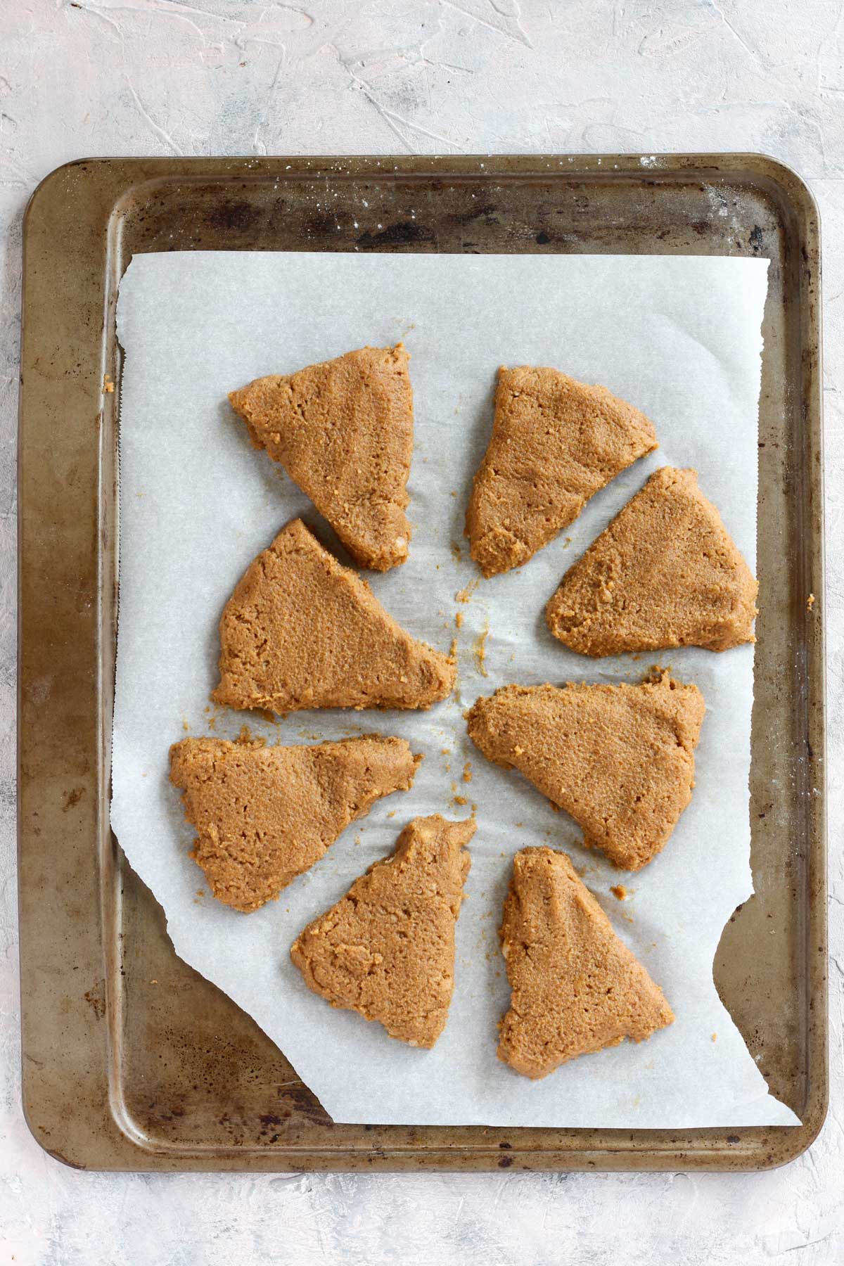Overhead shot of uncooked scones on baking sheet.