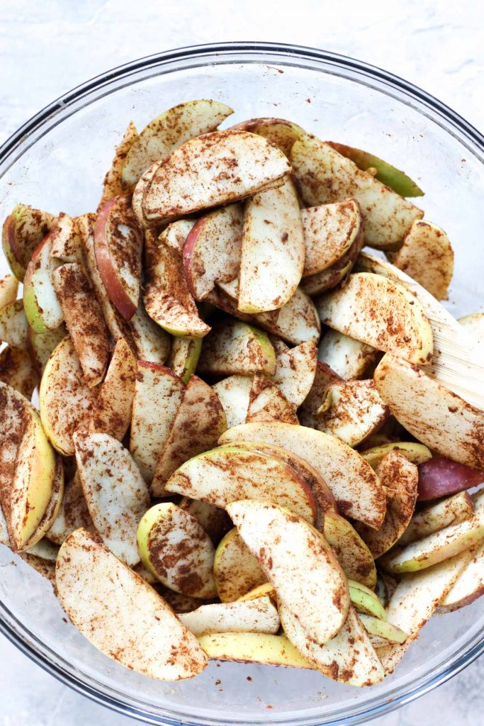 Mixing bowl with apple slices.