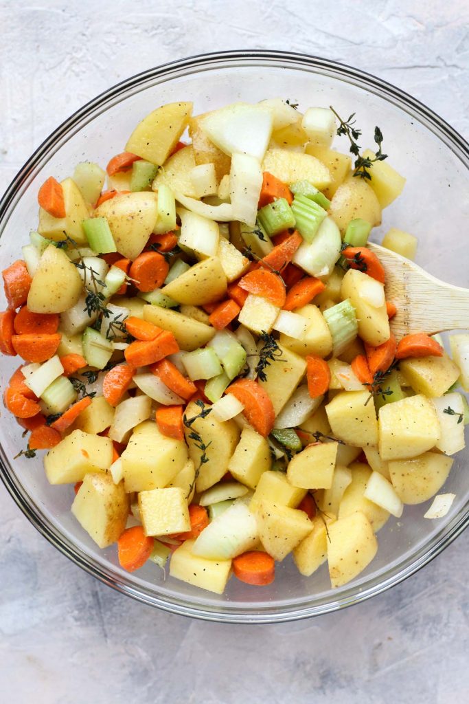 Bowl of chopped vegetables tossed in seasoning.