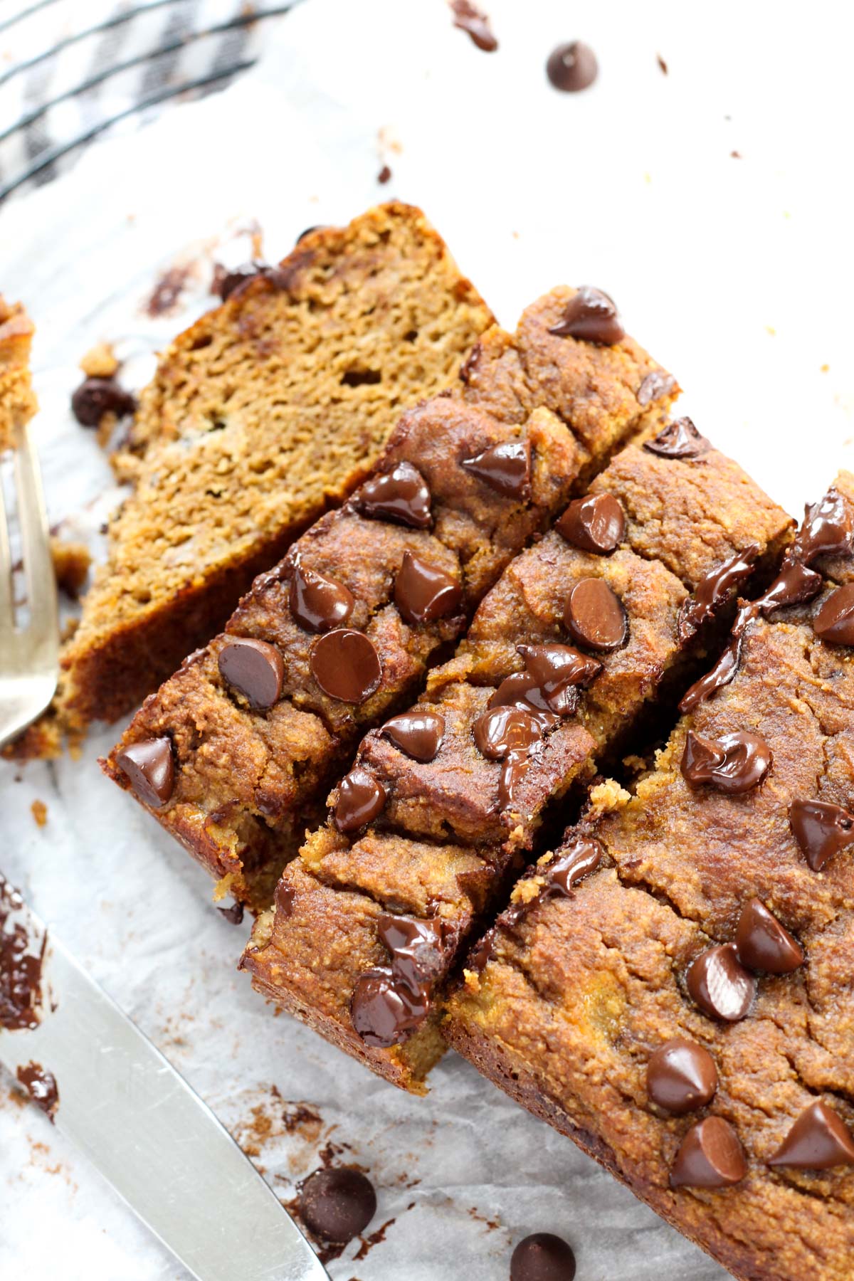 Side shot of pumpkin banana bread on parchment paper.