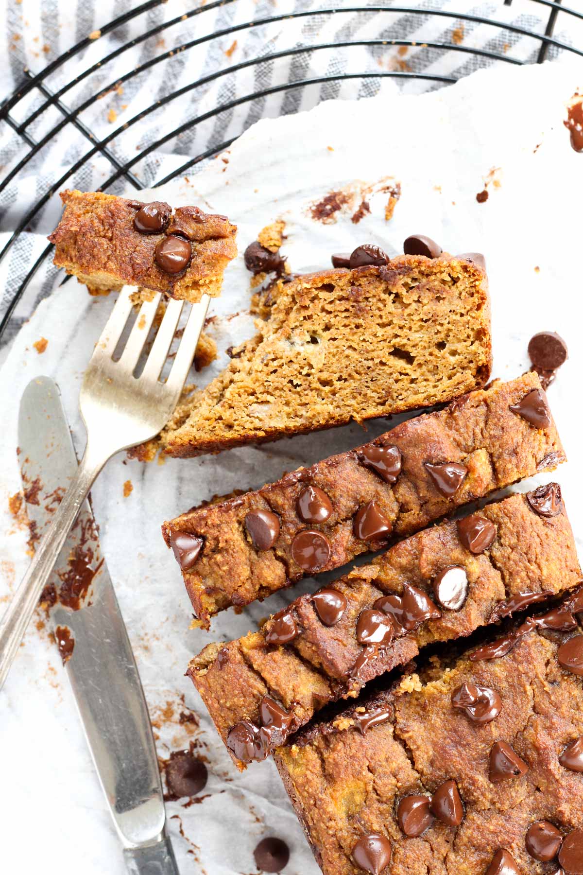 Overhead shot of pumpkin banana bread cut into thick slices with a fork on the side.