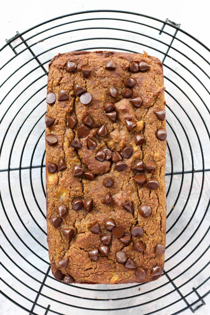 Pumpkin banana bread cooling on a metal rack.