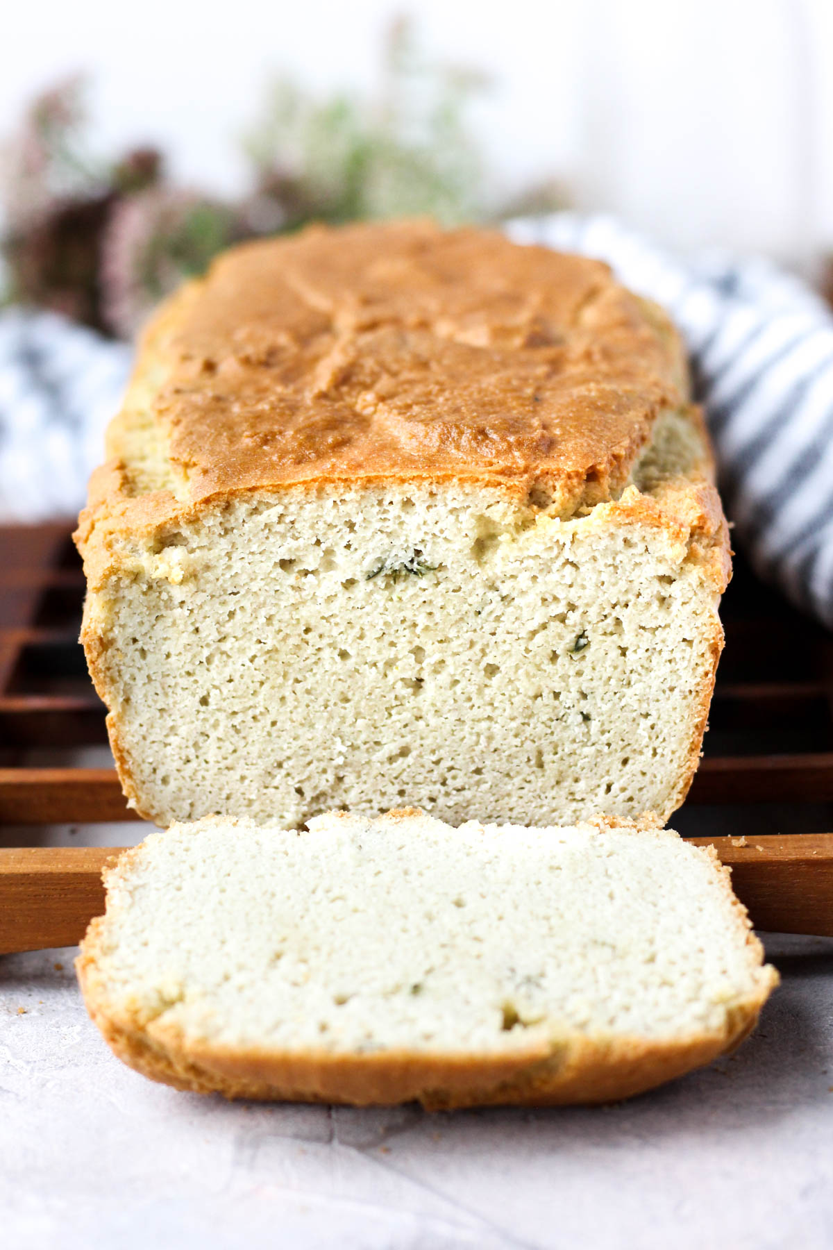 Head on shot of garlic herb loaf with one slice cut.