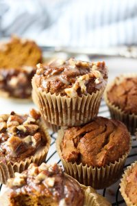 Pumpkin spice muffins stacked on top of each other.