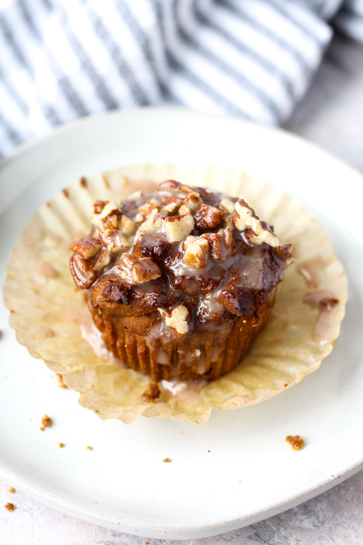 Pumpkin spice muffin on a white plate.