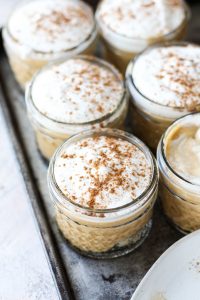 Pumpkin mousse cups lined up next to each other.