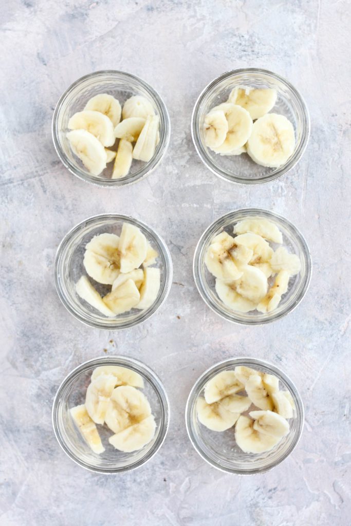 Banana slices in six glass cups.