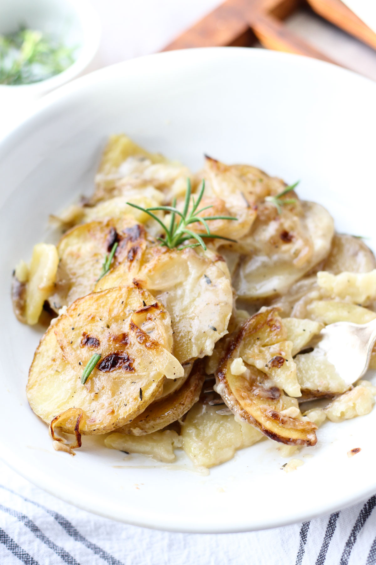 White plate of scalloped potatoes.