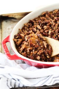 Close up of spoon scooping out sweet potato casserole.