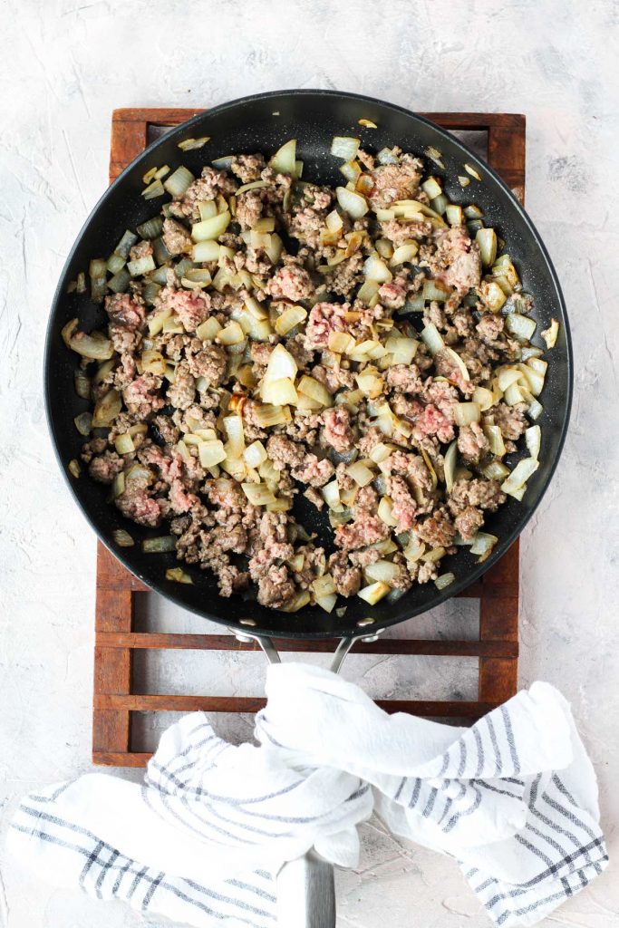 Meat and onions in saute pan.