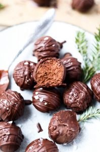 Dark chocolate peppermint truffle with a bite taken out.