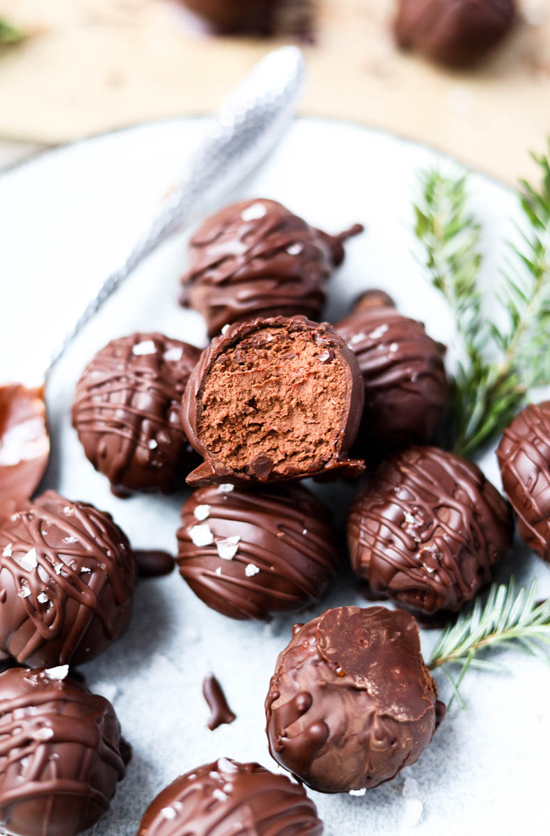 Dark chocolate peppermint truffle with a bite taken out.