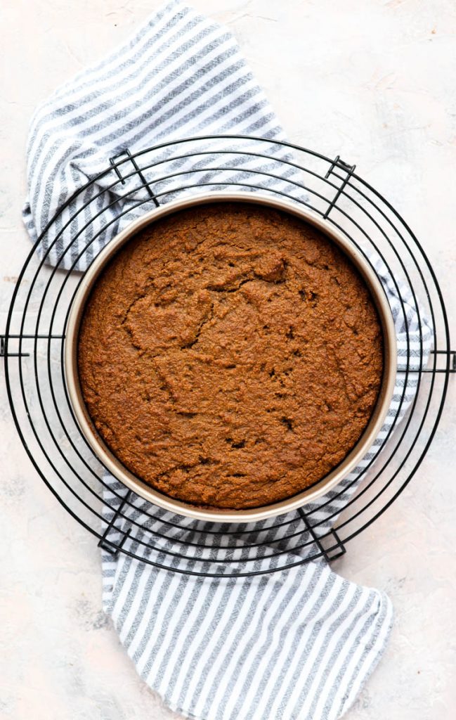 Baked cake cooling in round pan.