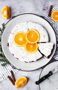 Overhead picture of gingerbread orange cake with orange slices on top.
