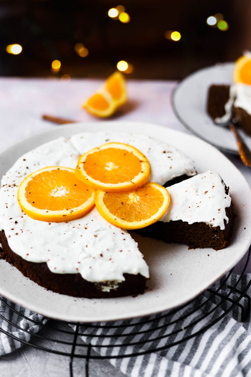Gingerbread orange cake on a white plate.