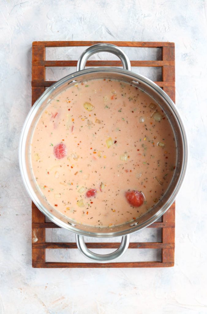All carrot tomato soup ingredients in the pot.