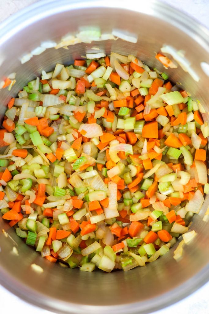 Vegetables sauteeing in pot.