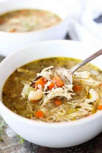 Close up picture of spoon scooping out soup.