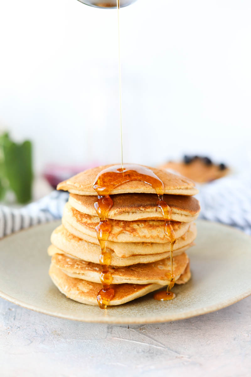 Syrup dripping onto pancake stack.