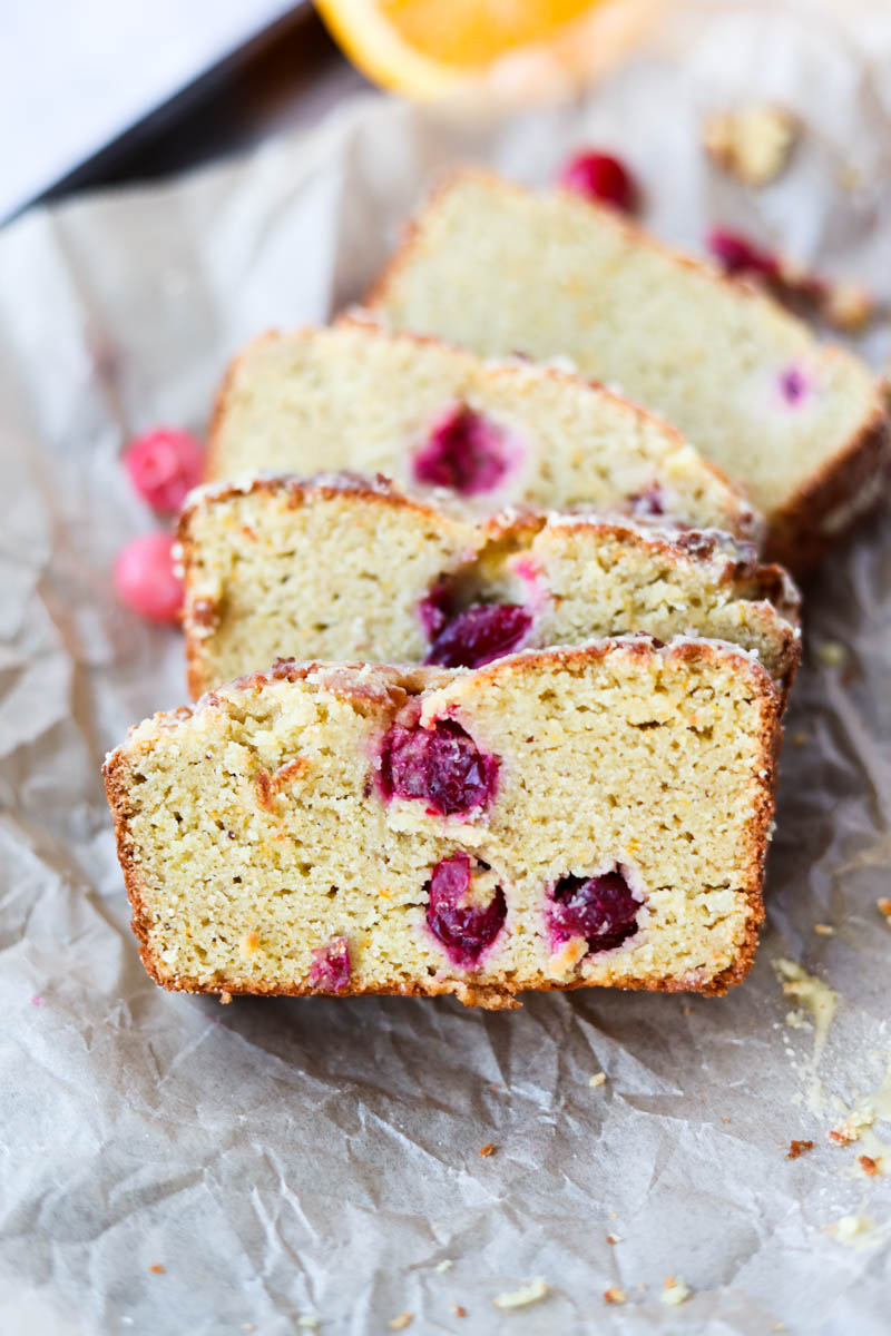 Close up picture of cranberry orange bread on parchment paper.