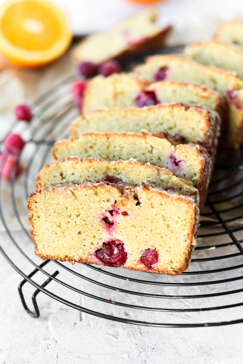 Close up picture of cranberry orange bread on parchment paper.