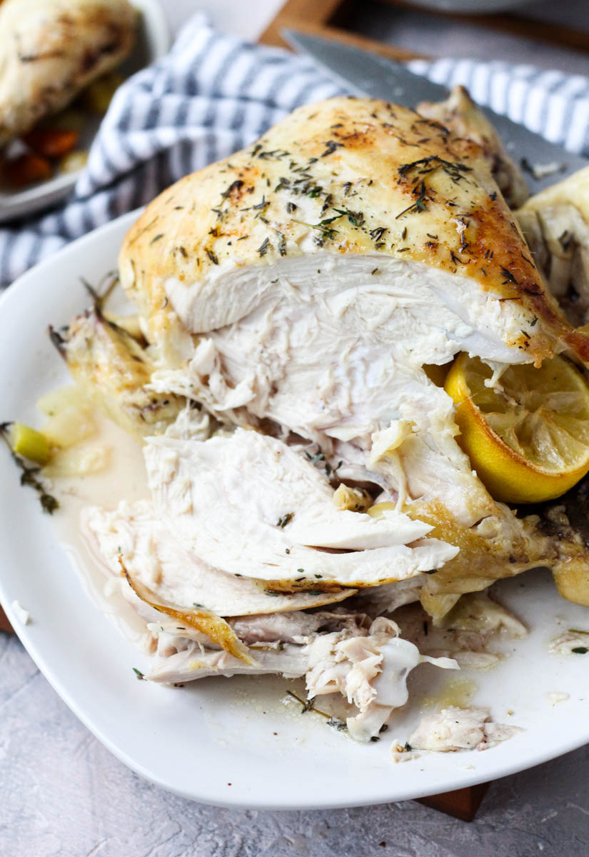 Whole roasted chicken sliced on the side.