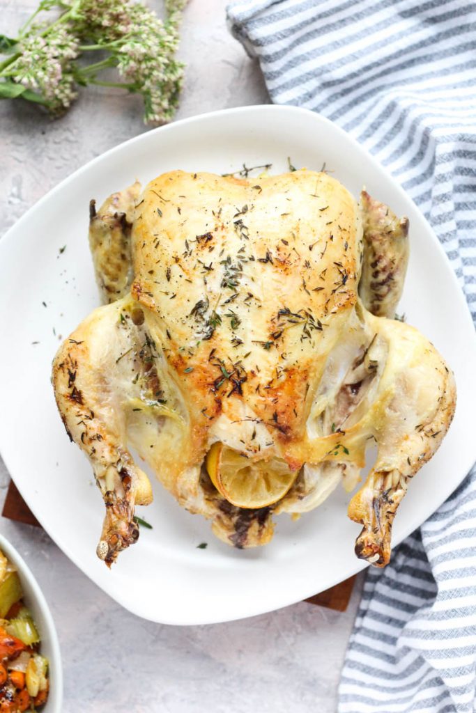 Baked chicken on a white plate.