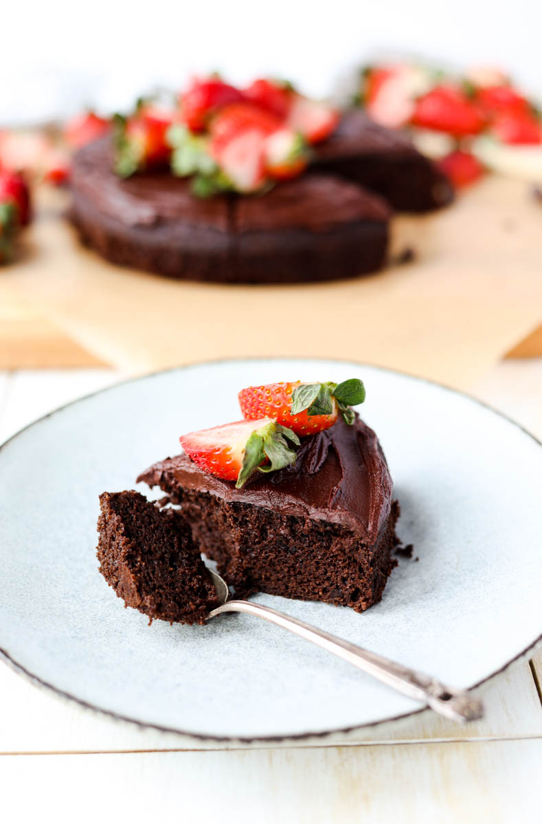 Slice of chocolate cake on a white plate.