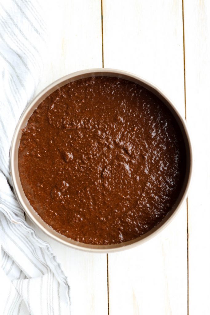 Cake batter in round cake pan.
