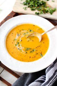 Spoon scooping out butternut squash soup.