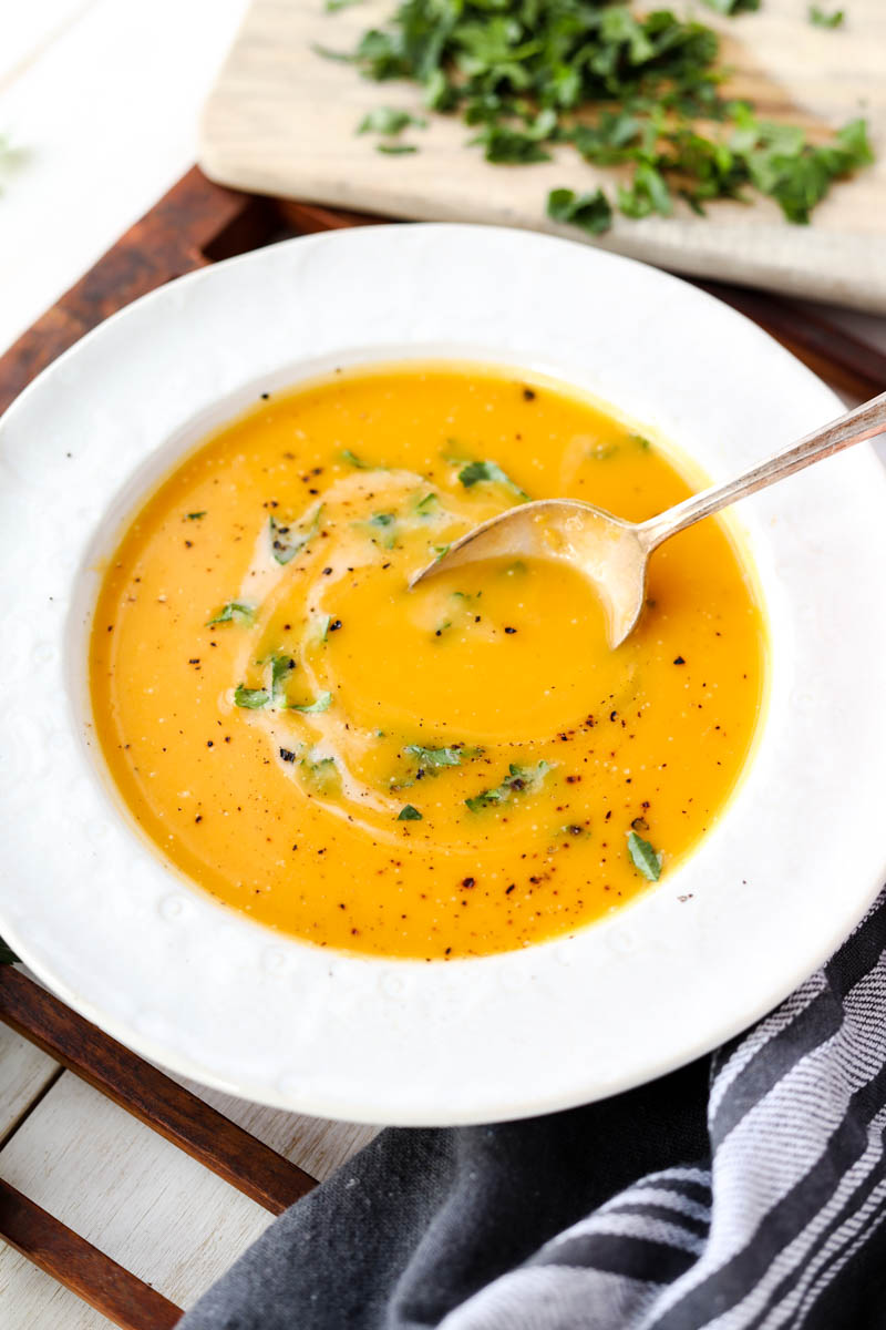 Spoon scooping out butternut squash soup.