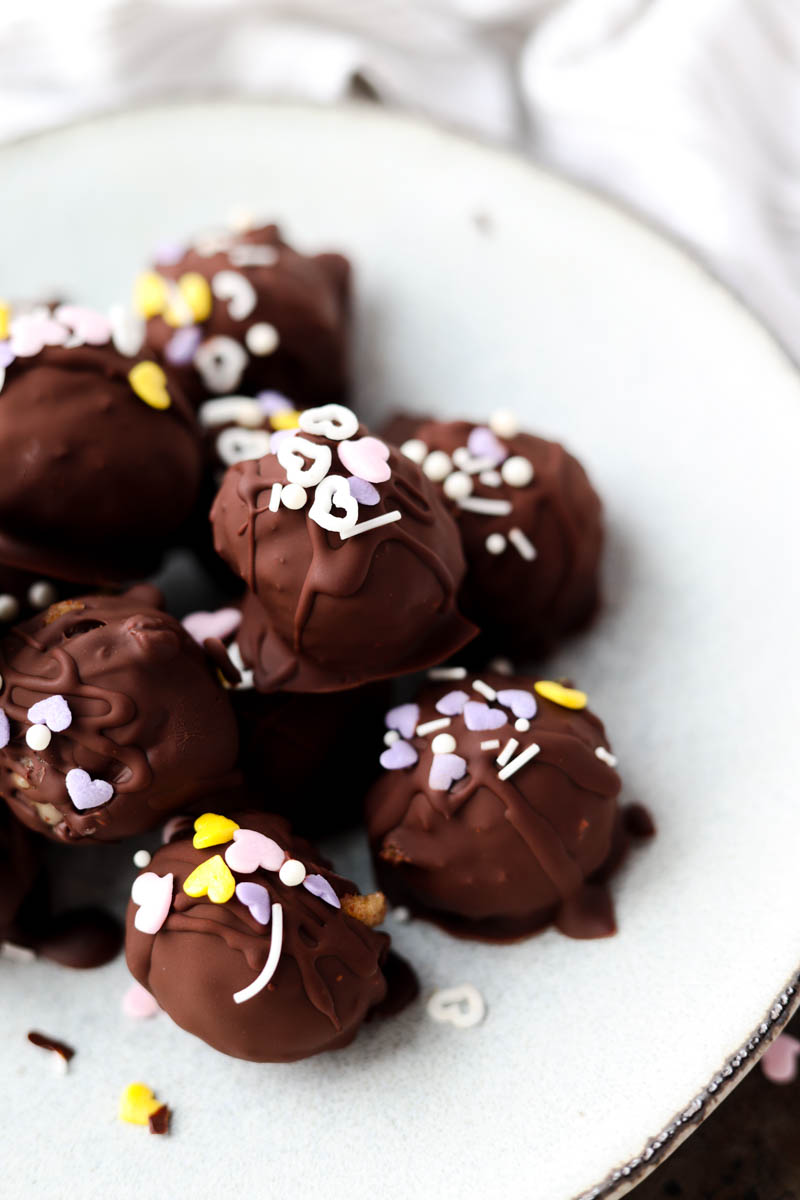 Chocolate covered banana bread truffles on a plate.