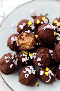 Banana bread truffle with a bite taken out.