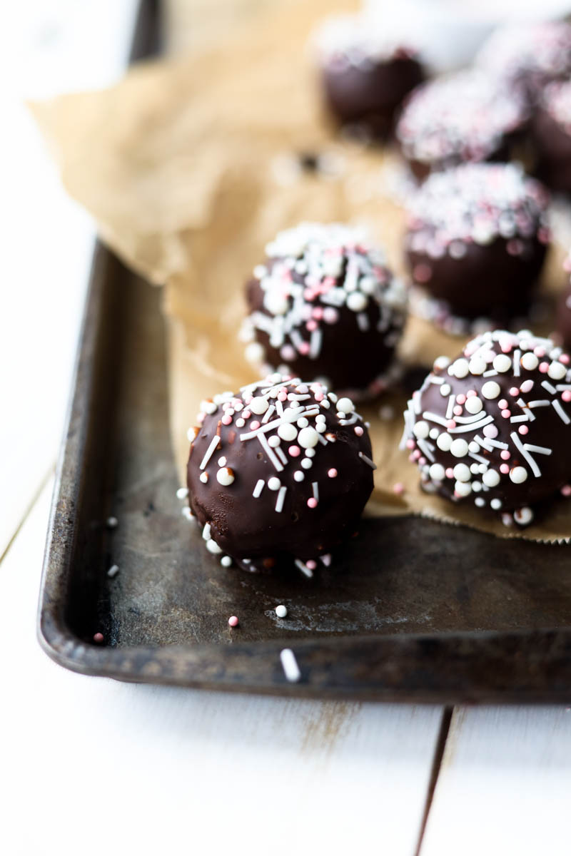 Cake pops on a baking sheet.