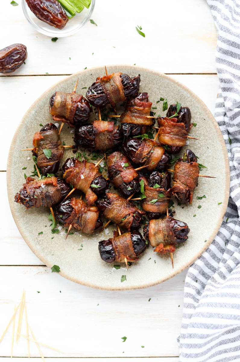 Large ceramic plate with bacon wrapped dates.