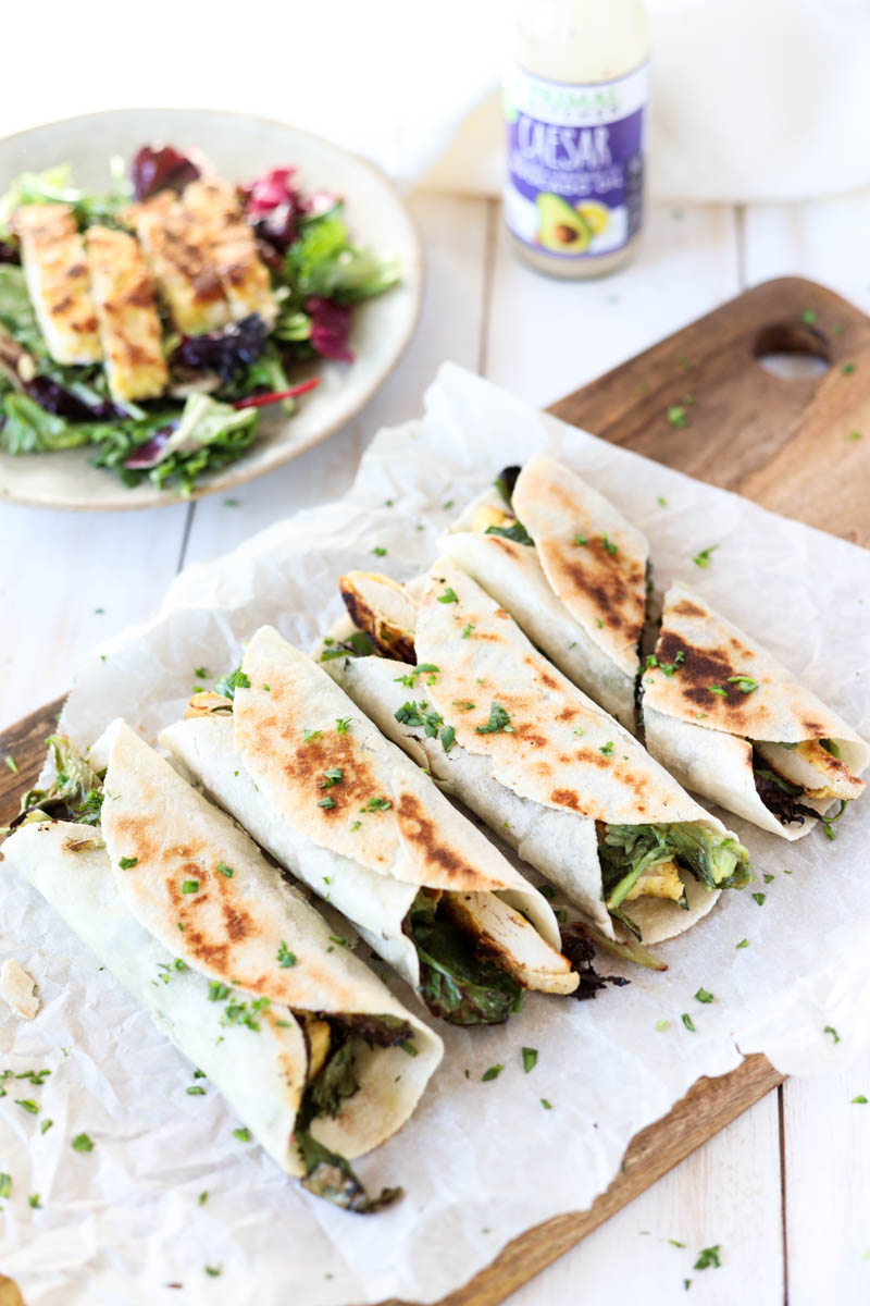 Crispy Chicken Ceasar salad wraps with fresh parsley on top.