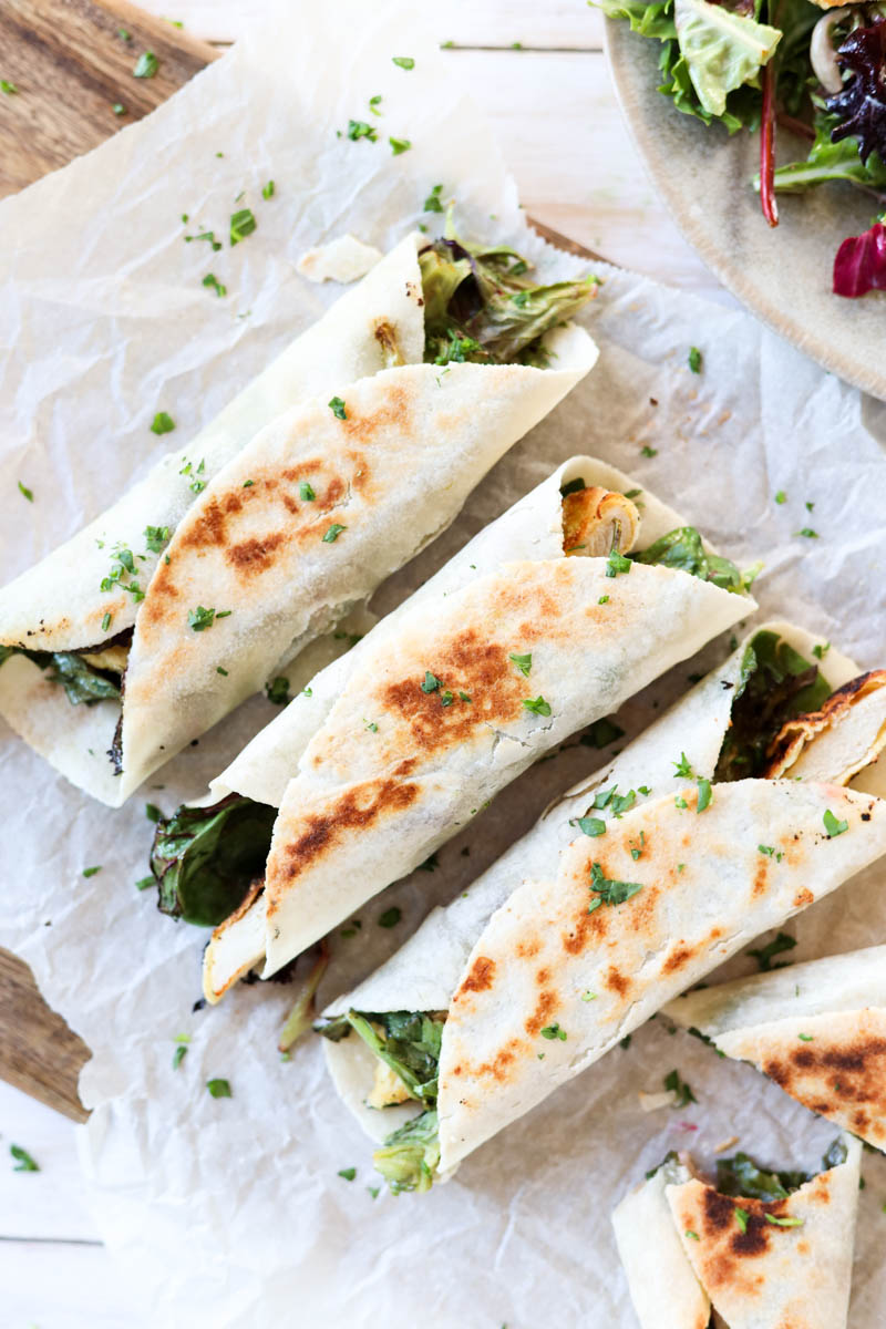 Overhead shot of crispy wraps on parchment paper.