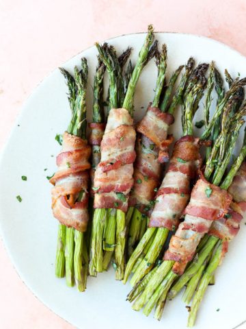Close up picture of plate with bacon wrapped asparagus.